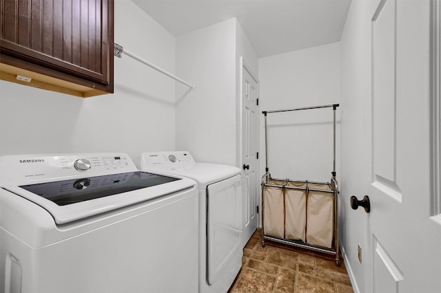 washroom featuring independent washer and dryer and cabinets