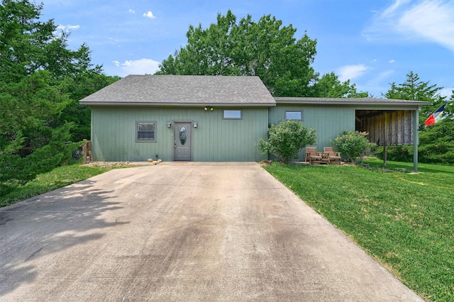 ranch-style house with a carport and a front lawn