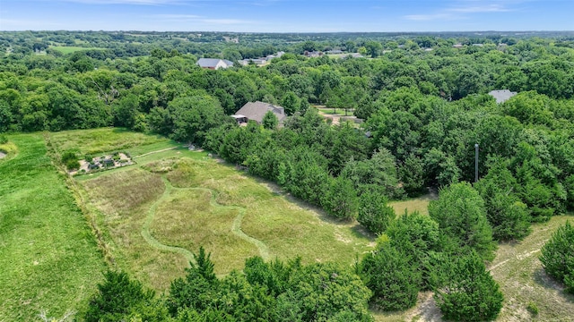 birds eye view of property with a forest view