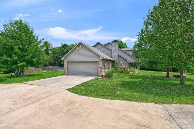 view of front of property featuring a front lawn and a garage