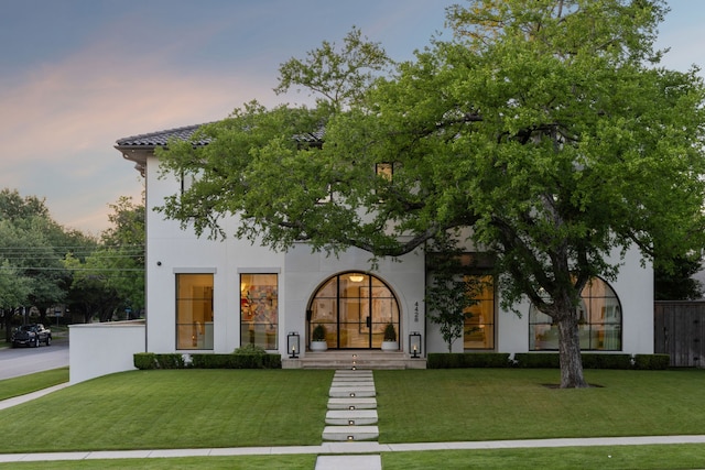 mediterranean / spanish house with a lawn