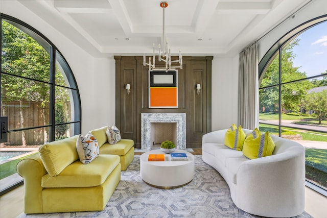 interior space featuring a notable chandelier, a wealth of natural light, light hardwood / wood-style floors, and a high end fireplace