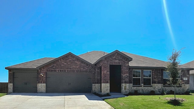 view of front of property with a garage and a front lawn