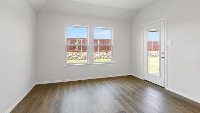 unfurnished room featuring vaulted ceiling and dark hardwood / wood-style flooring