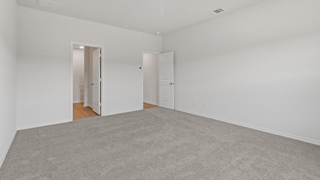 spare room with light colored carpet