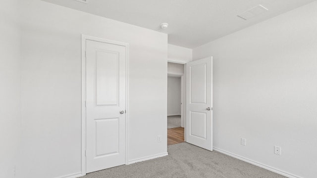 unfurnished bedroom featuring light carpet