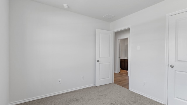 unfurnished bedroom with light carpet