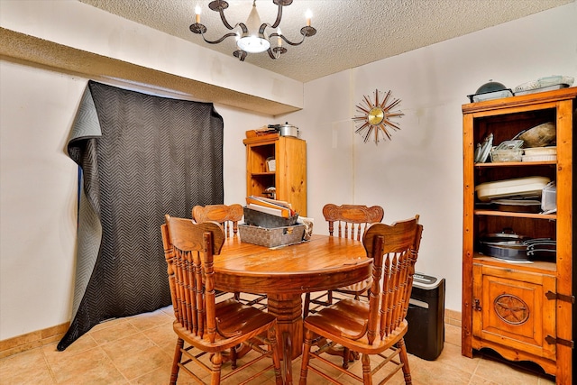 dining area with a textured ceiling, light tile patterned floors, and a notable chandelier