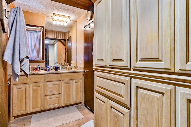 bathroom with vanity and a textured ceiling