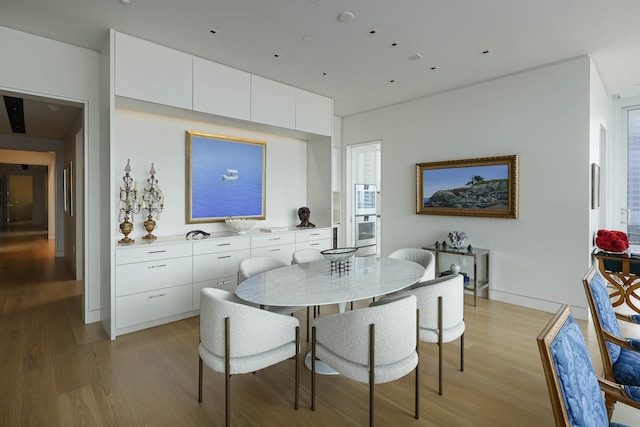 dining space featuring light wood-type flooring