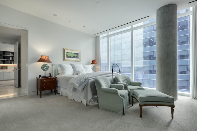 carpeted bedroom with expansive windows and multiple windows