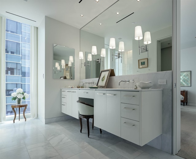 bathroom with an inviting chandelier and vanity