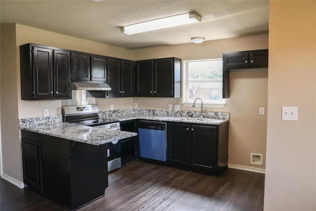 kitchen with dark wood-type flooring, stainless steel appliances, and light stone countertops