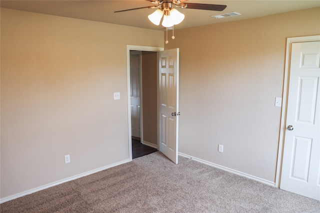 unfurnished bedroom with ceiling fan and carpet