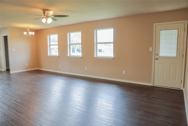 interior space with dark wood-type flooring and ceiling fan with notable chandelier