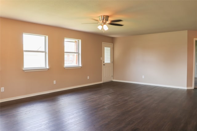 empty room with ceiling fan and dark hardwood / wood-style floors