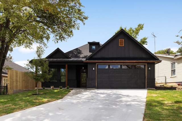 view of front of property with a garage and a front lawn