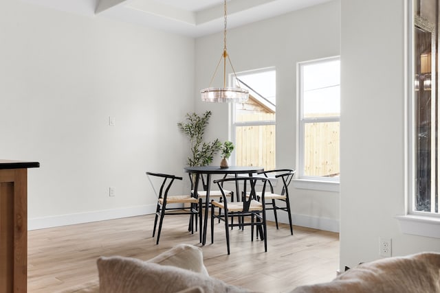 dining room featuring light wood-type flooring and an inviting chandelier