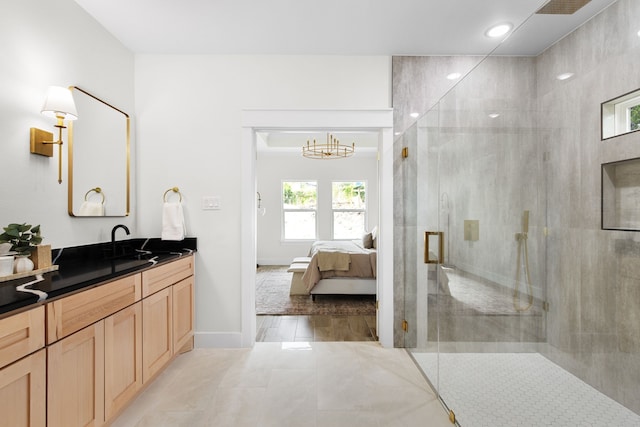 bathroom featuring tile patterned flooring, a shower with door, and vanity