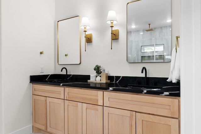 bathroom with tiled shower and vanity