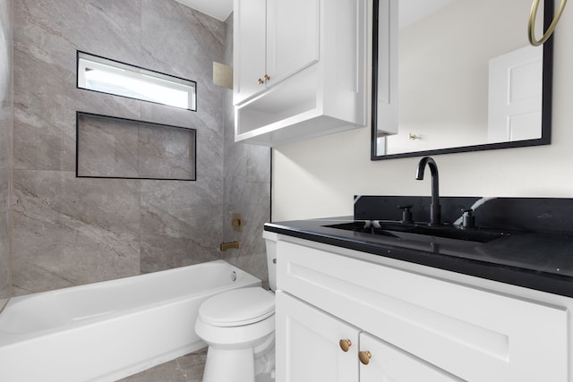 full bathroom with tiled shower / bath, toilet, and vanity