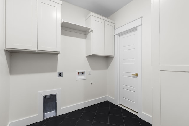 laundry room with dark tile patterned floors, gas dryer hookup, hookup for an electric dryer, washer hookup, and cabinets