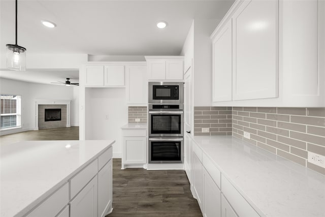 kitchen with pendant lighting, white cabinets, ceiling fan, and dark hardwood / wood-style flooring