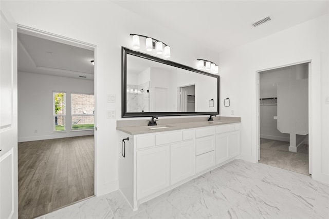 bathroom featuring wood-type flooring, vanity, and an enclosed shower