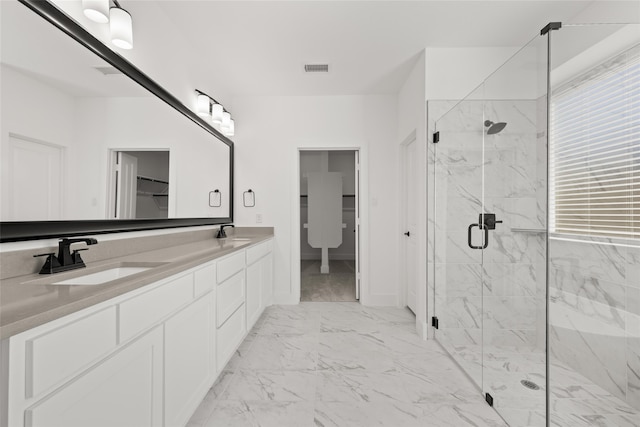 bathroom with walk in shower and vanity