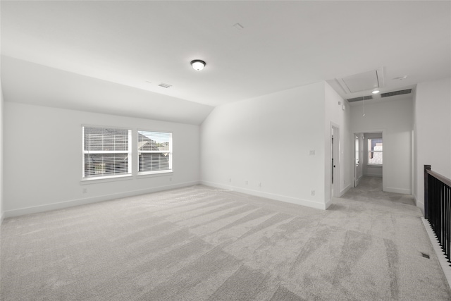 interior space with light colored carpet and lofted ceiling