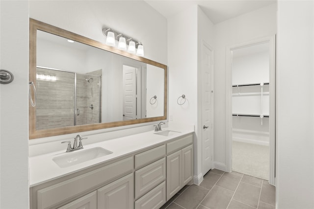 bathroom featuring vanity, an enclosed shower, and tile patterned flooring