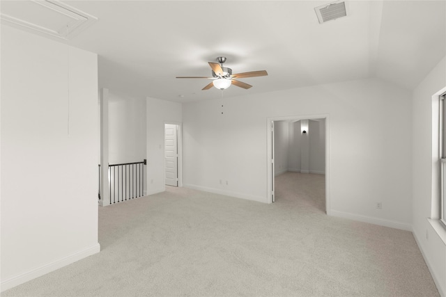 carpeted spare room with lofted ceiling and ceiling fan