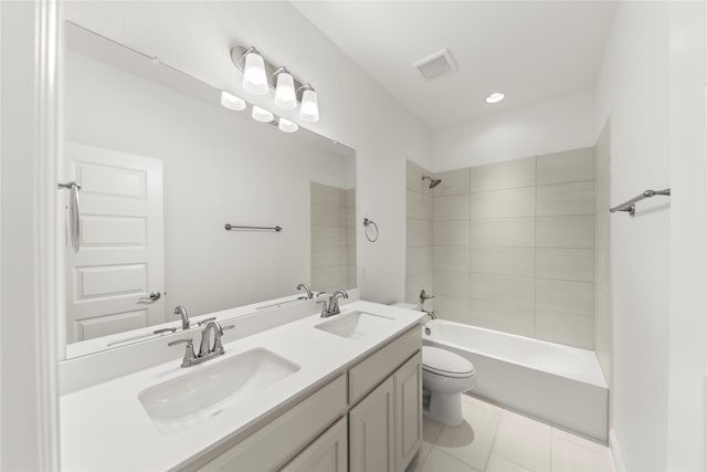 full bathroom with tiled shower / bath, tile patterned floors, toilet, and vanity