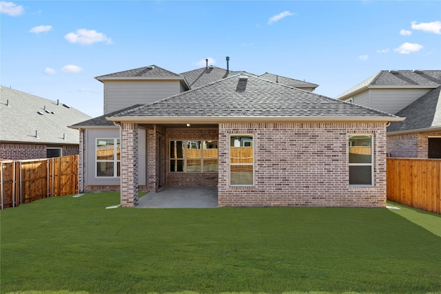 back of house with a yard and a patio area