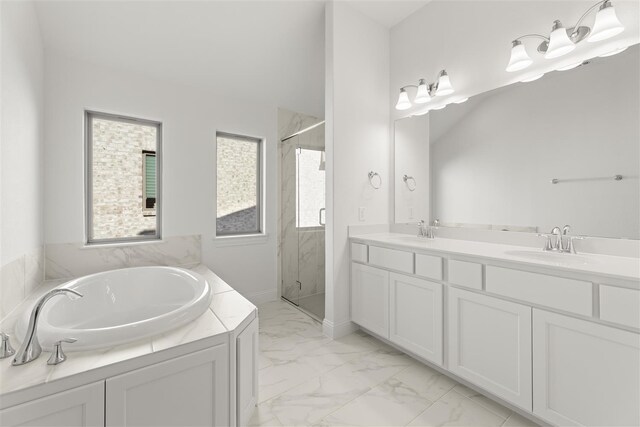 bathroom with vanity and shower with separate bathtub