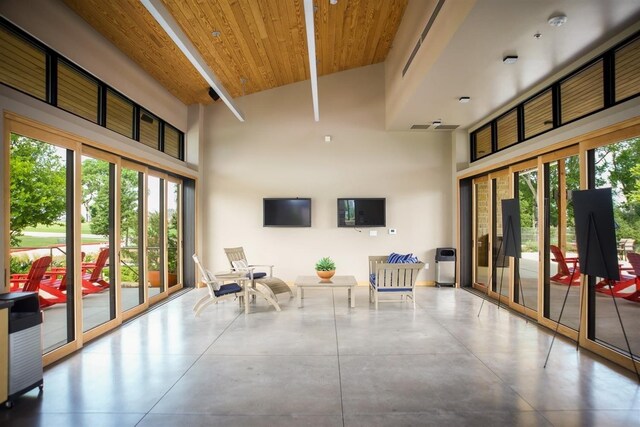 sunroom with wooden ceiling and vaulted ceiling