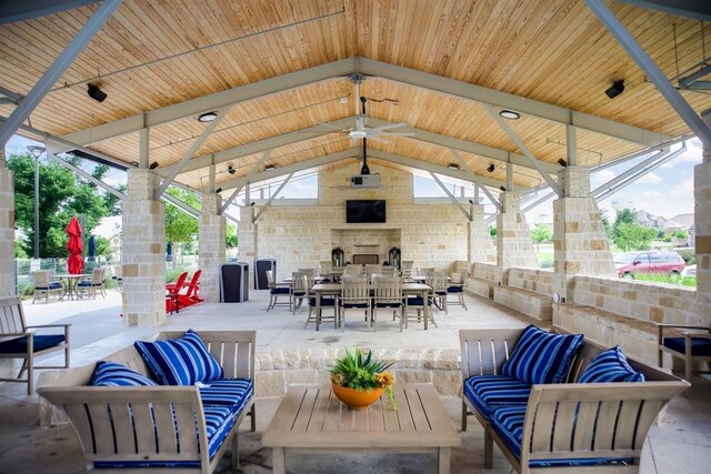 view of patio / terrace with a gazebo and an outdoor living space with a fireplace