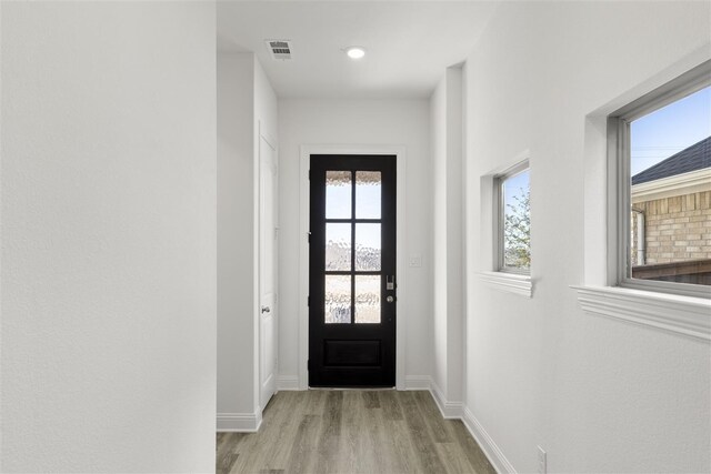 entryway with light hardwood / wood-style floors