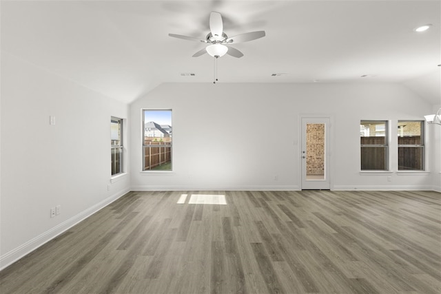 unfurnished living room with ceiling fan, hardwood / wood-style floors, and vaulted ceiling