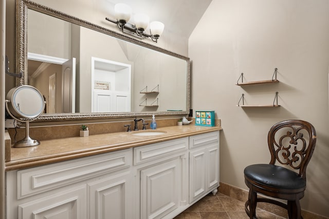 bathroom with tile patterned floors, ornamental molding, and vanity