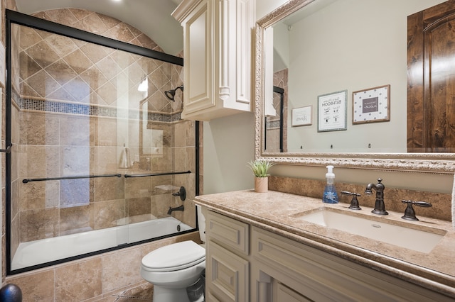 full bathroom with toilet, combined bath / shower with glass door, and vanity