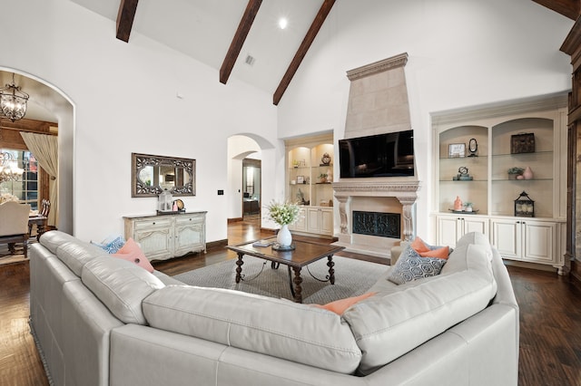 living room featuring dark hardwood / wood-style floors, beam ceiling, high vaulted ceiling, and a chandelier