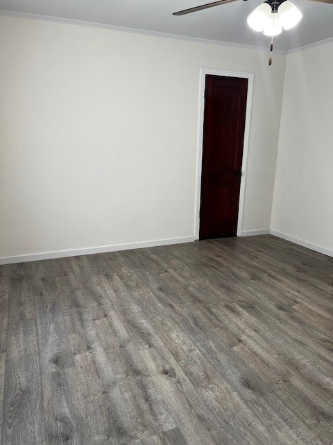 spare room featuring ornamental molding, dark hardwood / wood-style flooring, and ceiling fan