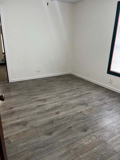 unfurnished room with dark hardwood / wood-style floors