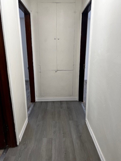 hallway with dark hardwood / wood-style floors