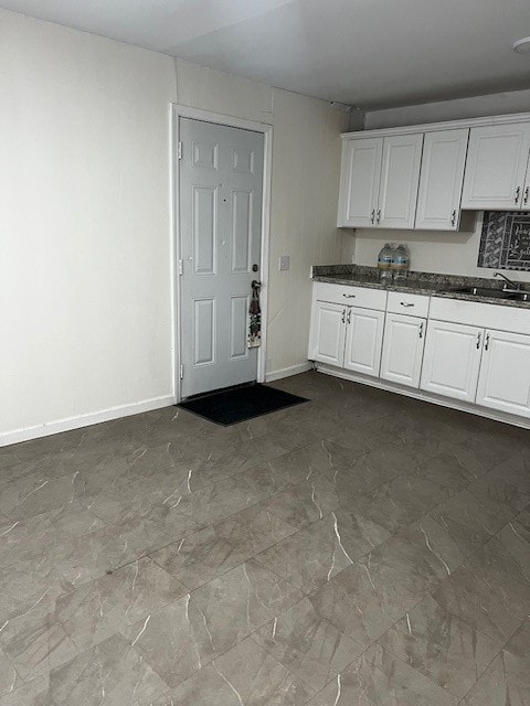 kitchen featuring white cabinets and sink