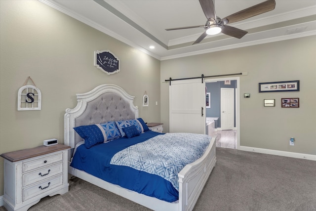 bedroom featuring a barn door, a raised ceiling, carpet, ceiling fan, and ornamental molding