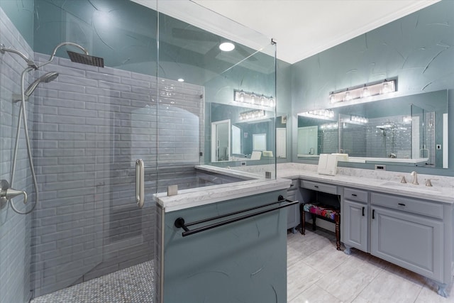 bathroom featuring ornamental molding, a tile shower, and vanity