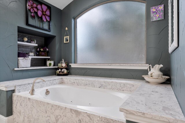 bathroom featuring a relaxing tiled tub