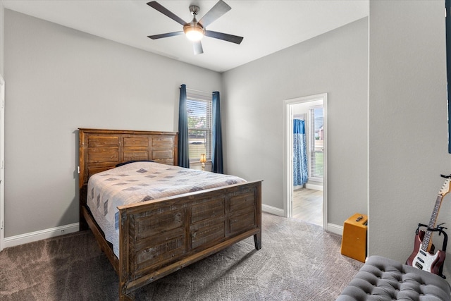 carpeted bedroom featuring ensuite bathroom, a ceiling fan, and baseboards